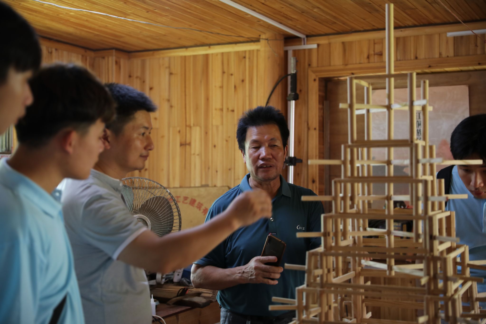 杨似玉大师利用鼓楼模型向实践团成员解说鼓楼od平台官方官网结构